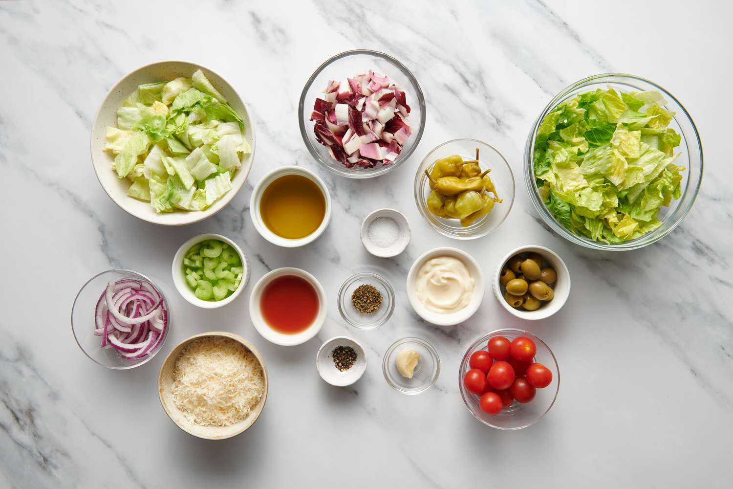 Salad ingredients laid out in separate bowls